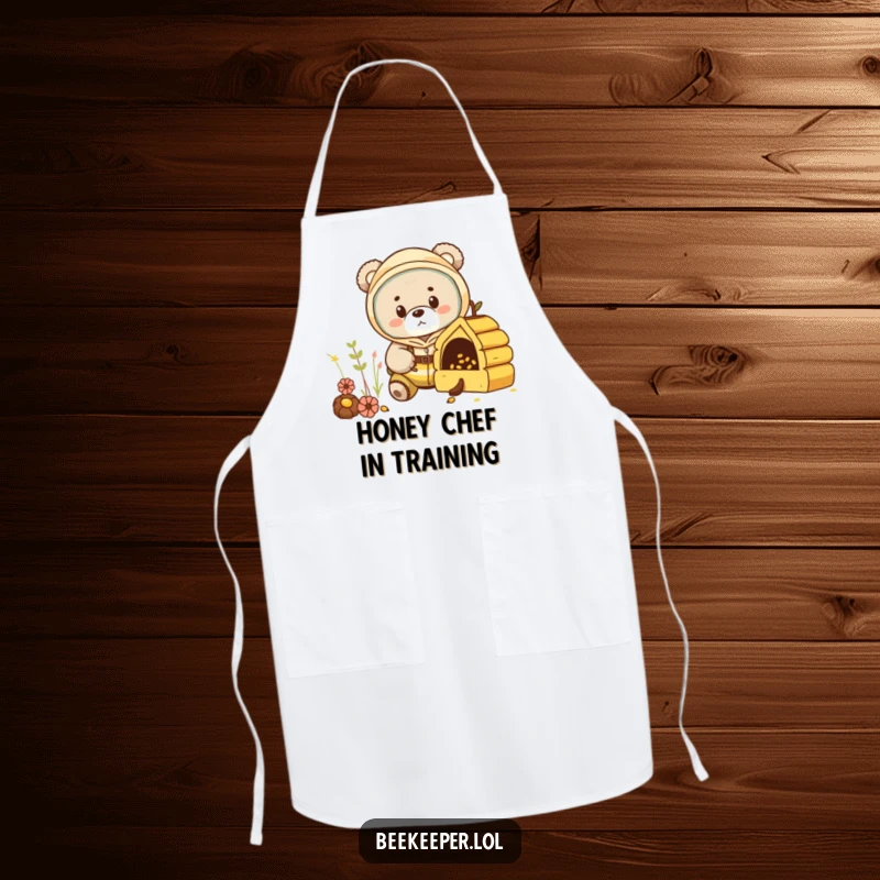 Funny bear cub in a beekeeper suit, peeking into a miniature hive on a kitchen apron, adding humor to cooking.